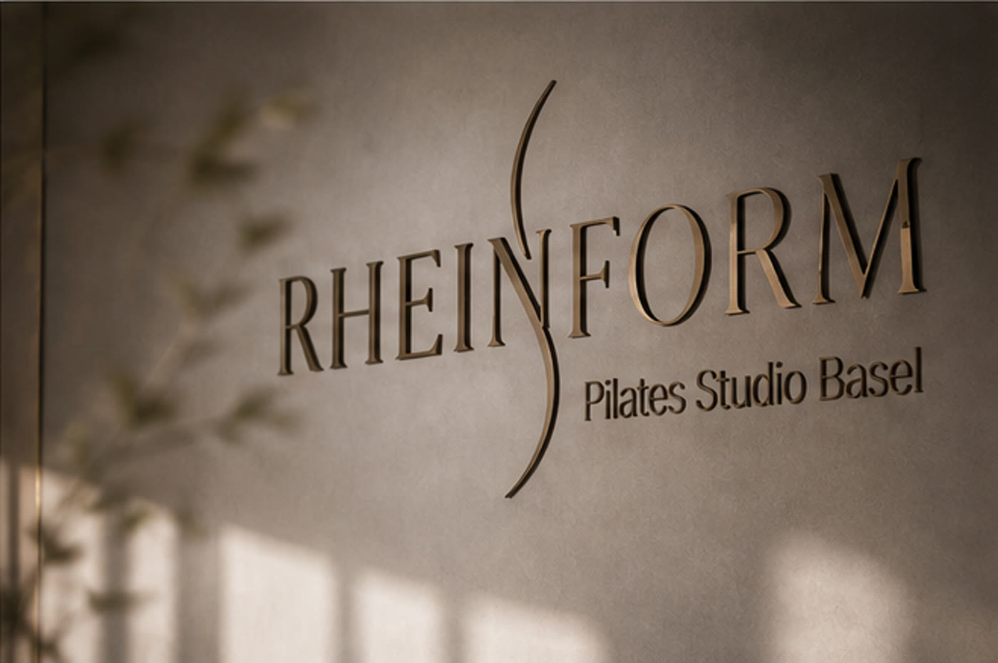 RheinForm logo as brass lettering on the studio wall